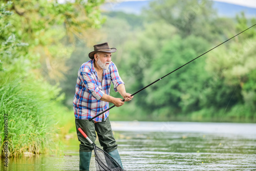 Senior man catching fish. Activity and hobby. Fishing freshwater lake pond river. Happiness is rod in your hand. Retired fisherman. Mature man fishing. Male leisure. Fisherman with fishing rod