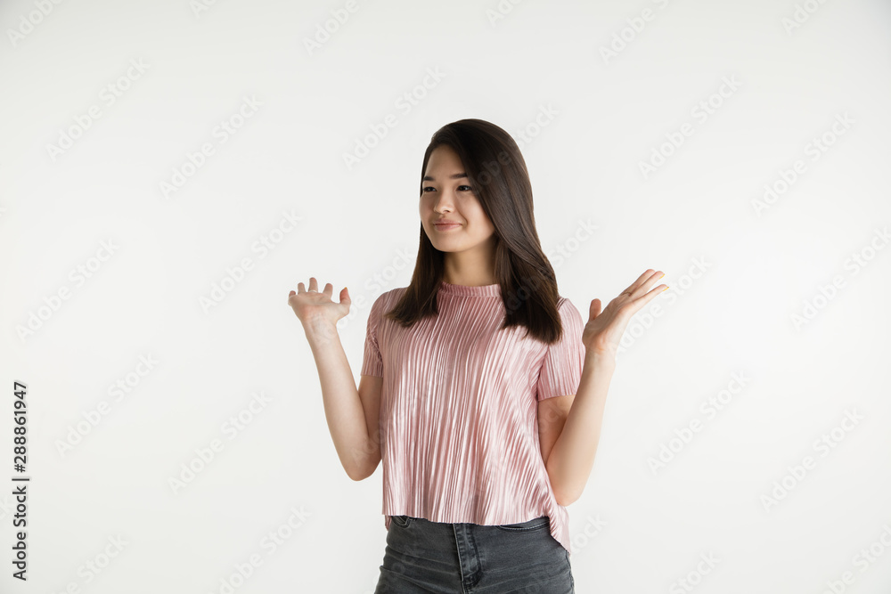 Beautiful female half-length portrait isolated on white studio background. Young emotional woman in casual clothes. Human emotions, facial expression concept. Showing an empty copyspace. Beautiful female half-length portrait isolated on white studio background. Young emotional woman in casual clothes. Human emotions, facial expression concept. Showing an empty copyspace.