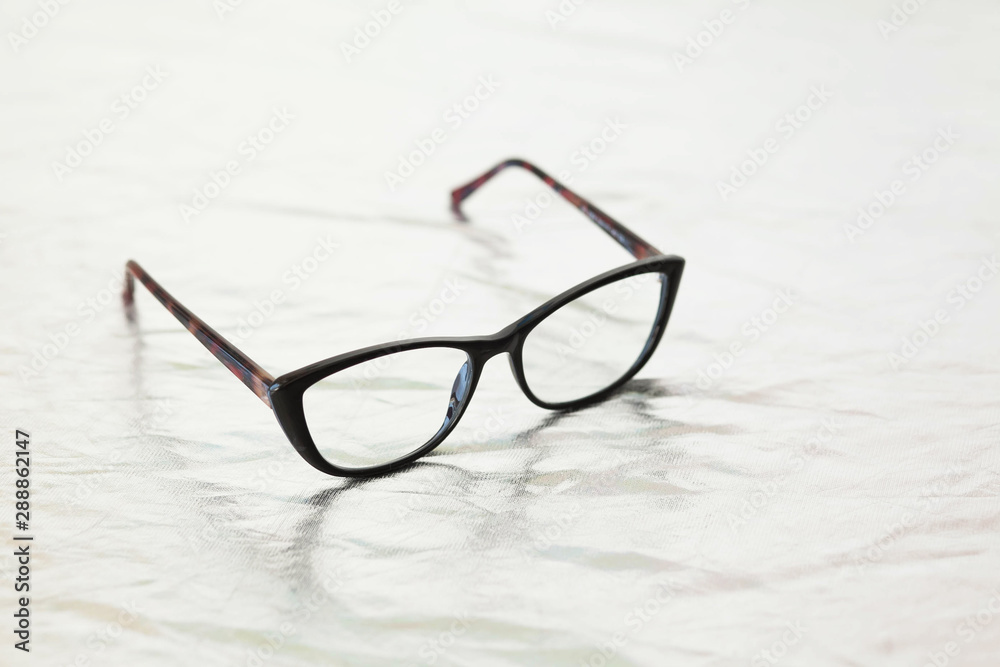 Fashionable stylish glasses on metalized background. Optics. Vision. Fashionable stylish glasses on metalized background. Optics. Vision.