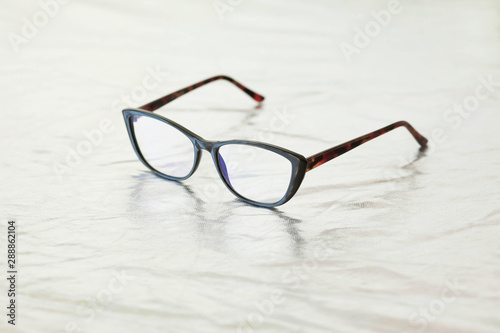 Fashionable stylish glasses on metalized background. Optics. Vision.