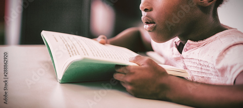 Girl reading a book in the classroom