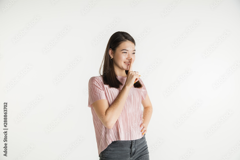 Beautiful female half-length portrait isolated on white studio background. Young emotional woman in casual clothes. Human emotions, facial expression concept. Whispering a secret, sales. Beautiful female half-length portrait isolated on white studio background. Young emotional woman in casual clothes. Human emotions, facial expression concept. Whispering a secret, sales.