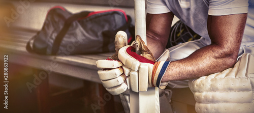 Stressed cricket player sitting on bench photo