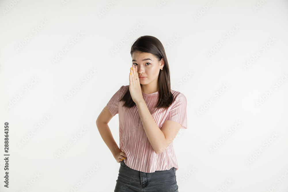 Beautiful female half-length portrait isolated on white studio background. Young emotional woman in casual clothes. Human emotions, facial expression concept. Whispering a secret, sales. Beautiful female half-length portrait isolated on white studio background. Young emotional woman in casual clothes. Human emotions, facial expression concept. Whispering a secret, sales.
