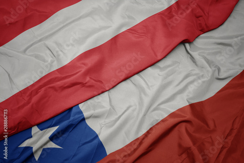 waving colorful flag of chile and national flag of austria.