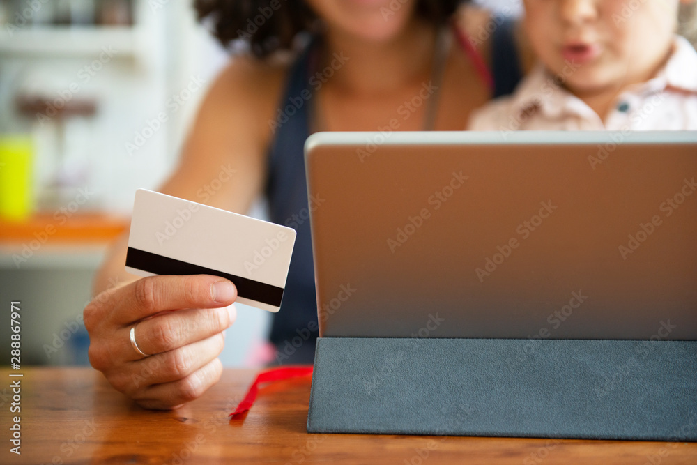 Mother paying with credit card from home Mother paying with credit card from home