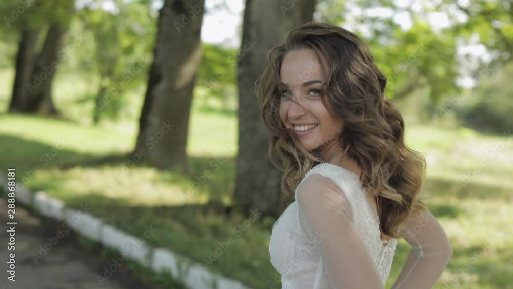 Beautiful and lovely bride in wedding dress running in the park. Slow motion Beautiful and lovely bride in wedding dress running in the park. Slow motion