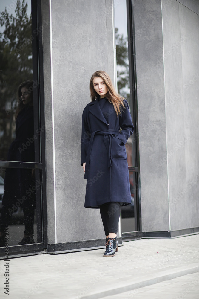 Beautiful girl in a coat in business downtown Beautiful girl in a coat in business downtown