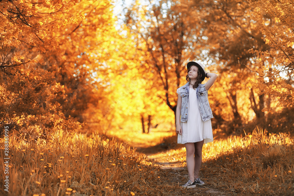 Girl walking in the autumn park. Autumn in the city, girl with dad for a walk. Parents are walking with little children. Autumn park people Girl walking in the autumn park. Autumn in the city, girl with dad for a walk. Parents are walking with little children. Autumn park people