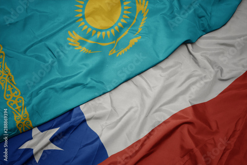waving colorful flag of chile and national flag of kazakhstan.