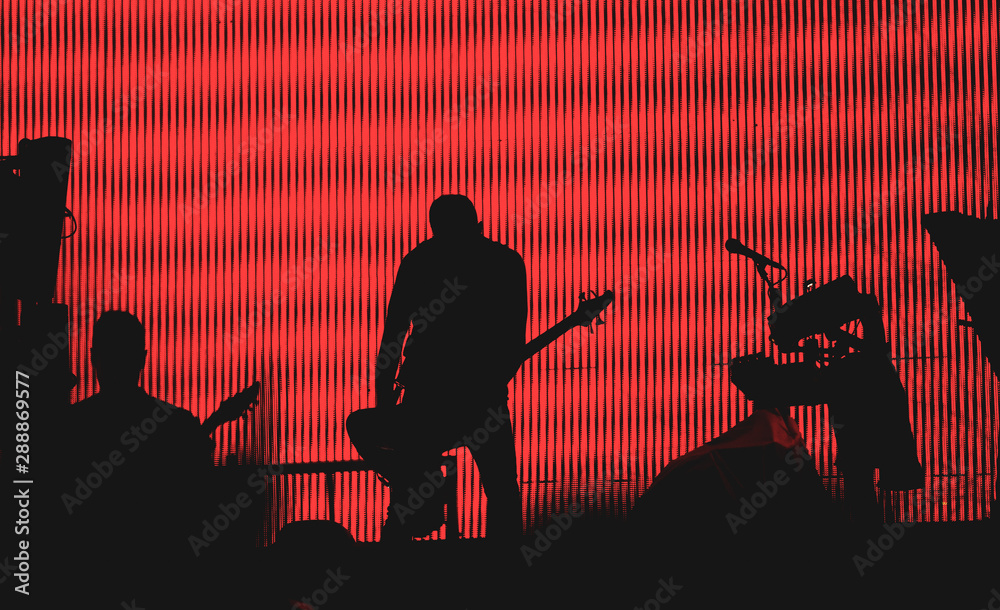 silhouette of a guitarist on stage during concert