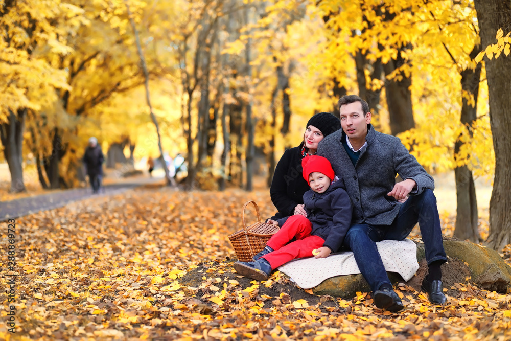 Family in autumn park in the afternoon