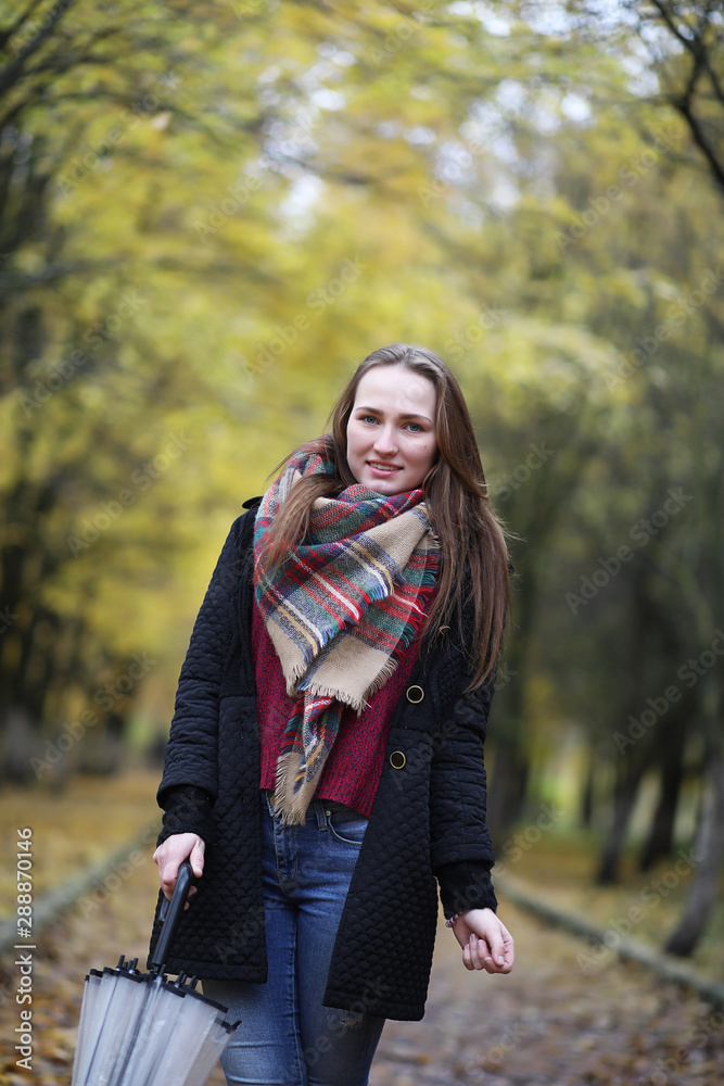 Young girl on a walk in the autumn park Young girl on a walk in the autumn park