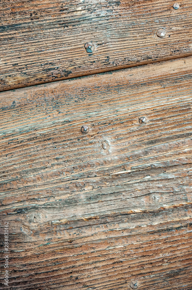 Obraz premium Wooden panels and boards of a rural house, Italy. Walls and ornaments in painted wood for the country house, ruined by time.