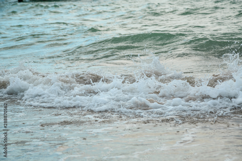 background of waves beating on a sandy beach in stormy weather background of waves beating on a sandy beach in stormy weather