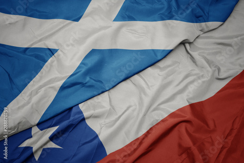 waving colorful flag of chile and national flag of scotland.