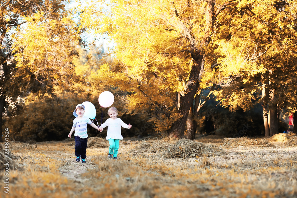 Little children are walking in autumn park Little children are walking in autumn park