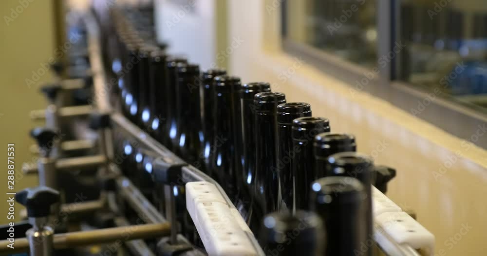 conveyor with wine bottles at the factory. wine production conveyor with wine bottles at the factory. wine production