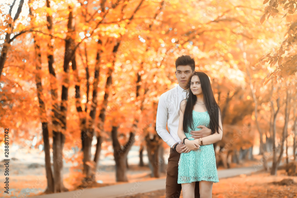 Young couple on a walk in autumn park