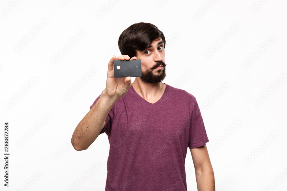 Handsome brunet bearded man with mustaches holding black bank card. Concept of cashless shopping. Handsome brunet bearded man with mustaches holding black bank card. Concept of cashless shopping.