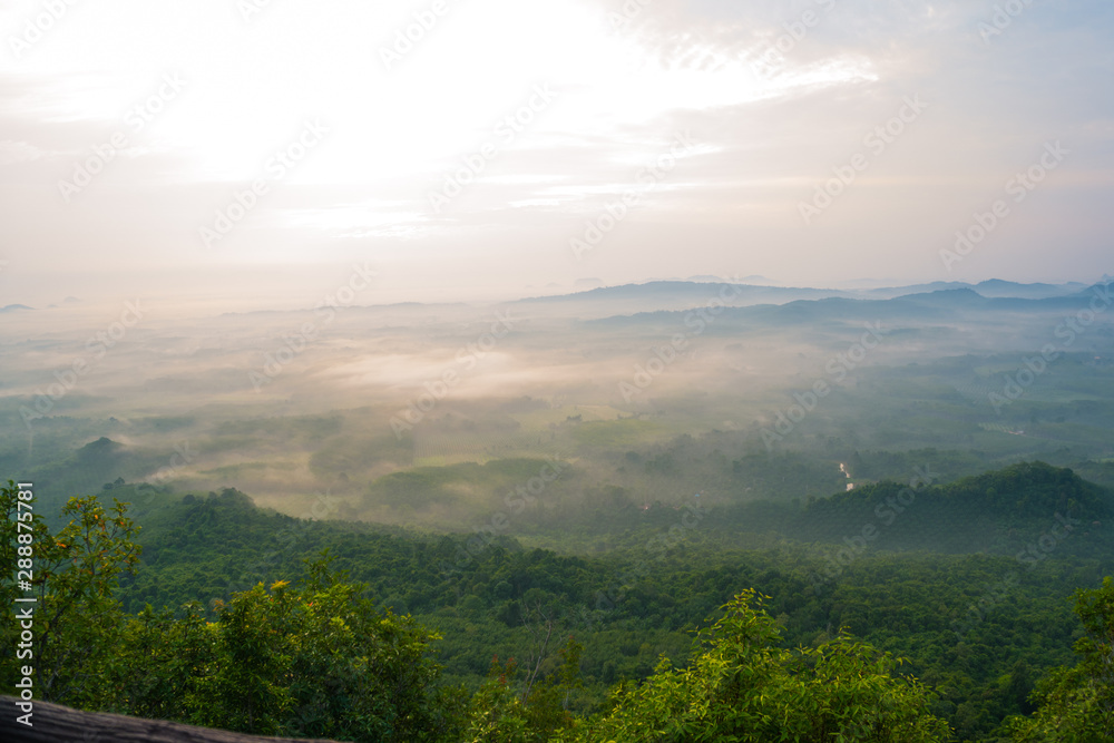 Obraz premium Magical sunet with sea of clouds. Landscape photo was taken from Wang Pha Mek, highlands of Trang, Thailand.