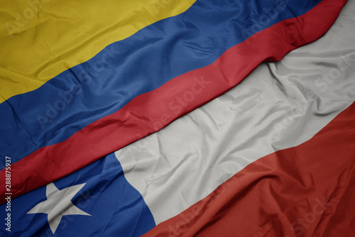 waving colorful flag of chile and national flag of colombia.