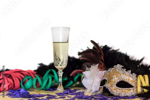 Festive background with Carnival Mask, Serpentines, Confetti and glass of champagne