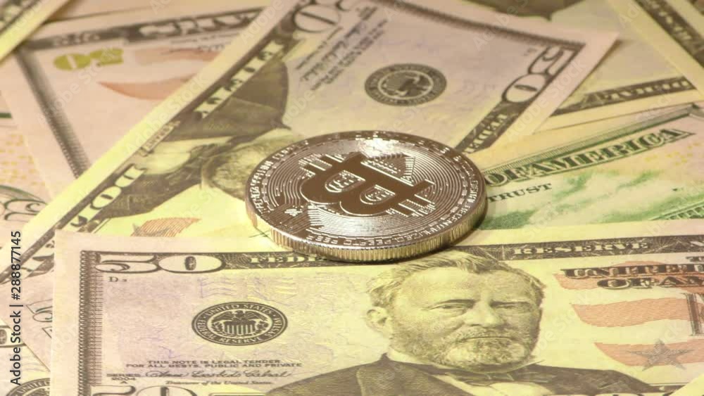 Gold Bit Coin BTC coins rotating on bills of 50 dollars. Worldwide virtual internet cryptocurrency. Gold Bit Coin BTC coins rotating on bills of 50 dollars. Worldwide virtual internet cryptocurrency.