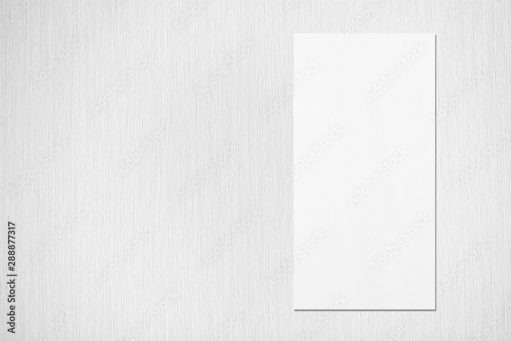 Empty white vertical rectangle price-list or menu mockup with soft shadows on neutral light grey textured background. Flat lay, top view. Copy space for text. Empty white vertical rectangle price-list or menu mockup with soft shadows on neutral light grey textured background. Flat lay, top view. Copy space for text.
