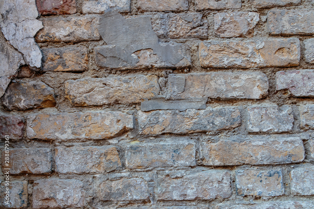 A rock. Brick wall. Background. Close-up. A rock. Brick wall. Background. Close-up.