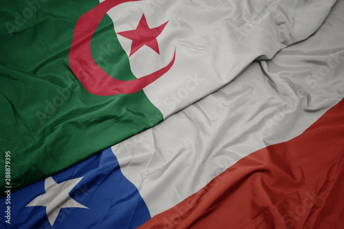 waving colorful flag of chile and national flag of algeria.