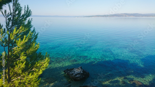 Rocky beach, bue transparent sea in Istria, Croatian coast