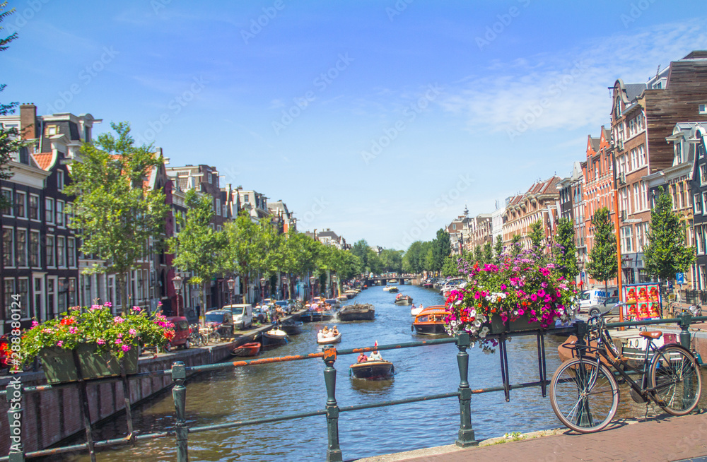 Beautiful Amsterdam, The Netherlands, with flowers and bicycles on the bridge in summer