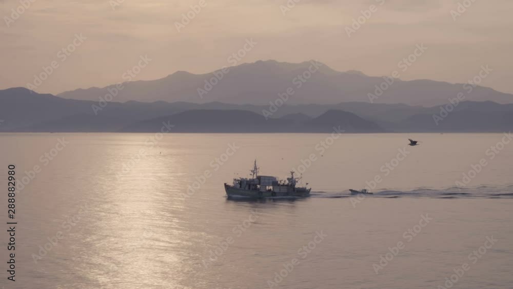 Magical scene of ship in calm sea going trough sun path Magical scene of ship in calm sea going trough sun path