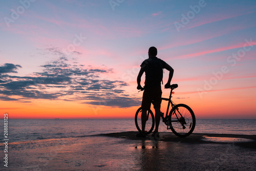 Pedaling into Daybreak: Cyclist's Seascape Journey