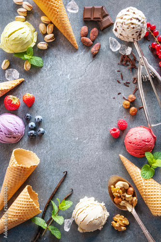 Various varieties of ice cream on gray stone background