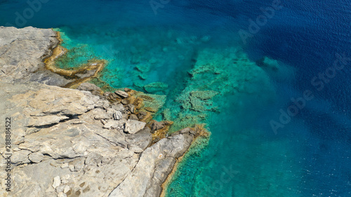 Aerial drone photo of iconic small chapel of Agia Anna built just above emerald rocky pebble beach, Amorgos island, Cyclades, Greece