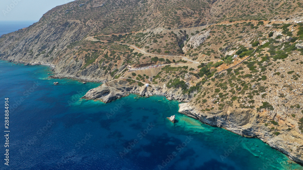 Aerial drone photo of iconic small chapel of Agia Anna built just above emerald rocky pebble beach, Amorgos island, Cyclades, Greece