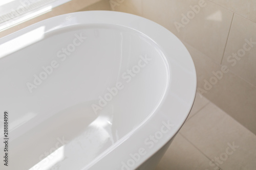 Pure white bathroom interior with separate bathtub. Bathroom with big windows