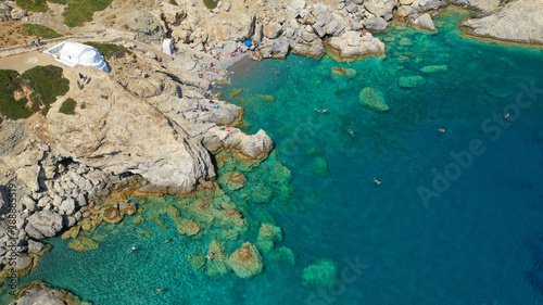 Aerial drone photo of iconic small chapel of Agia Anna built just above emerald rocky pebble beach, Amorgos island, Cyclades, Greece