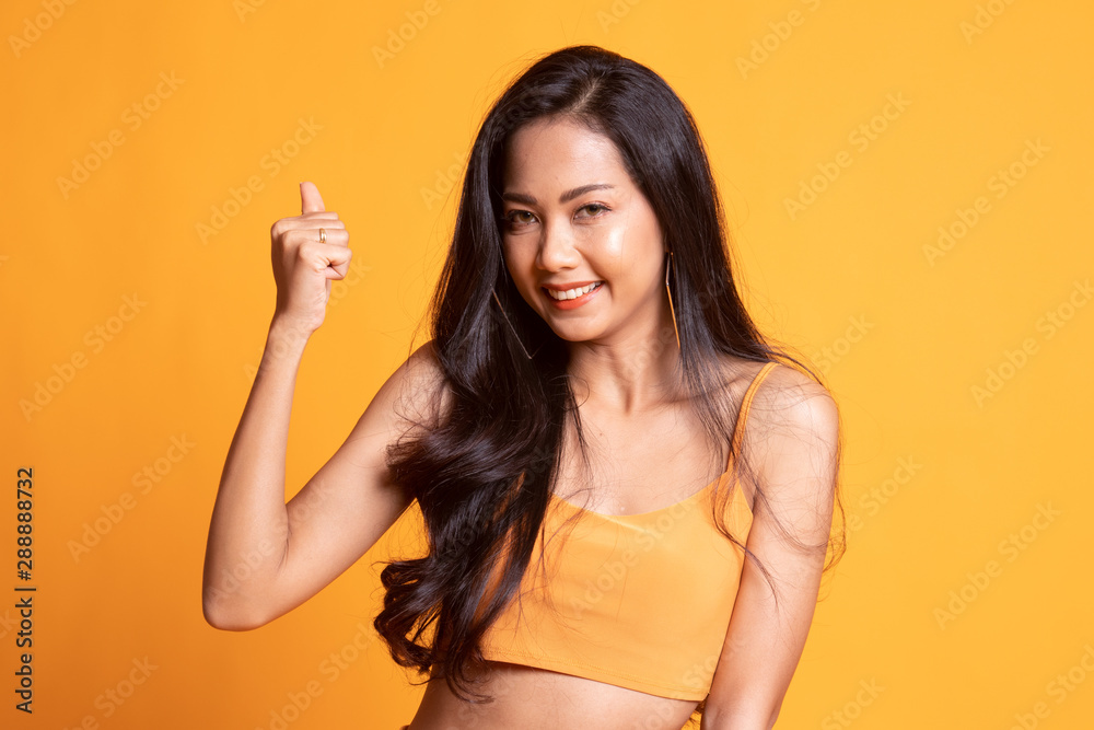 Successful young Asian woman hold fist up. Successful young Asian woman hold fist up.