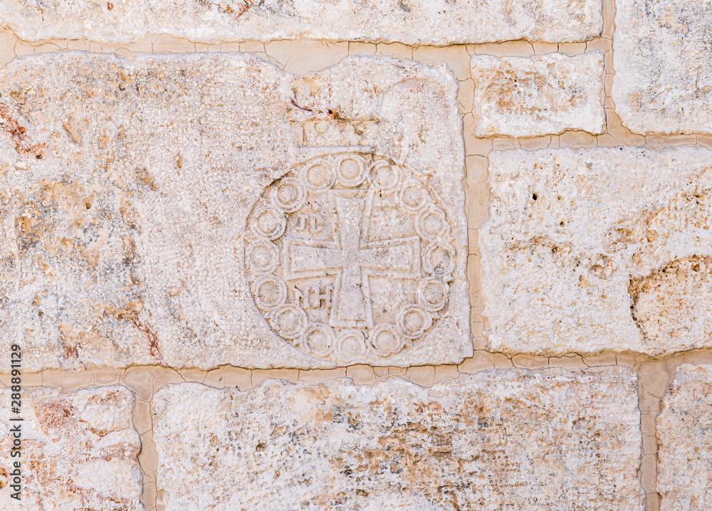 Cross carved in stone on the wall of the Church of St. John the Baptist in the Old City in Jerusalem, Israel