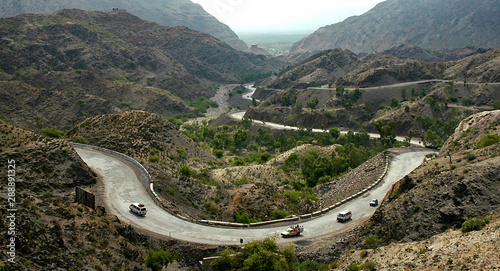 The Khyber Pass in northern Pakistan. Vehicles are climbing the Khyber Pass on the Pakistan side. The Khyber Pass is a vital road link from Peshawar, Pakistan to Landi Kotal and Torkham in Afghanistan photo