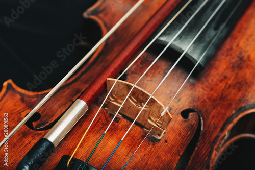 Close up image of a vilolin lying on black background photo