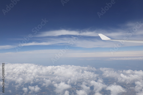Wing of airplane in the blue sky