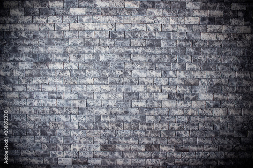 Grey brick wall texture. Old rough brickwork. Dark grunge background