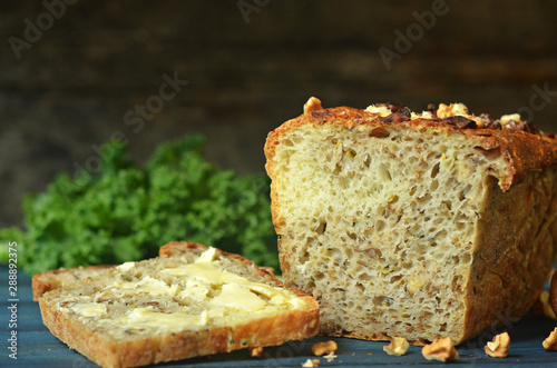 A slice of bread with butter. Zucchini bread with nuts