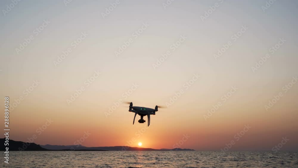 Drone flying above sea. Beautiful red and orange colors at sunset Drone flying above sea. Beautiful red and orange colors at sunset
