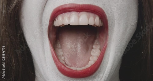 Just another scream - close-up of a teenage girl, who is made-up for Halloween or a costume party. Rehearsing different facial expressions, she is letting out a long yell - ProRes
