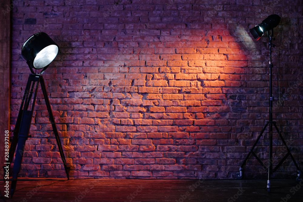 Old retro red brick wall being lit by a stage light bulb light. Constant  light modifier projecting light on it Stock Photo | Adobe Stock
